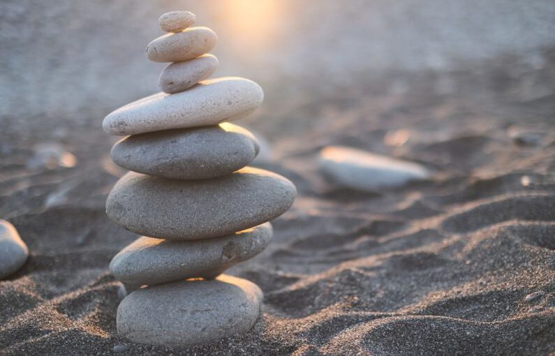Work Balance - stack of stones on brown sand