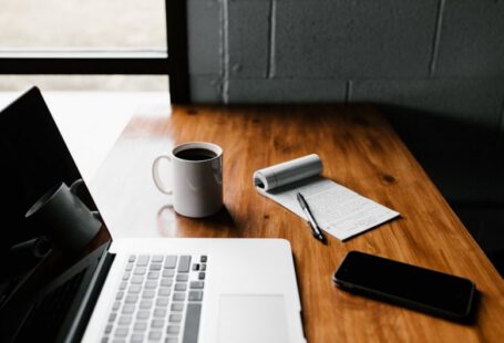 Job Offer Negotiation - MacBook Pro, white ceramic mug,and black smartphone on table