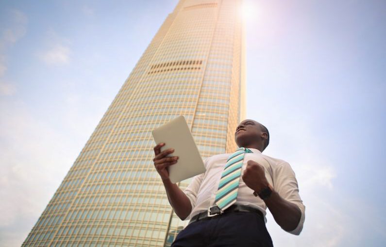 Achievement Showcase - man standing near high-rise building