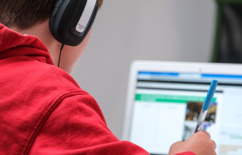 Online Learning - person in red shirt wearing black and gray headphones