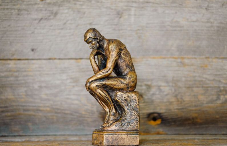 Critical Thinking - green ceramic statue of a man