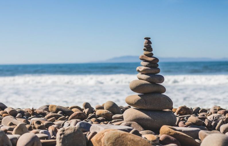 Work Life Balance - stack rock on seashore