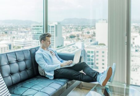 Freelance Profile - man sitting on sofa while using laptop