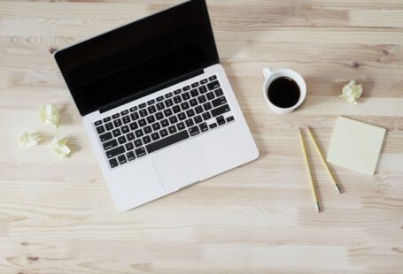 Resume Design - turned off MacBook Pro beside white ceramic mug filled with coffee