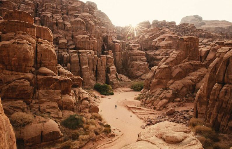 Internship Experience - a person walking through a canyon in the desert