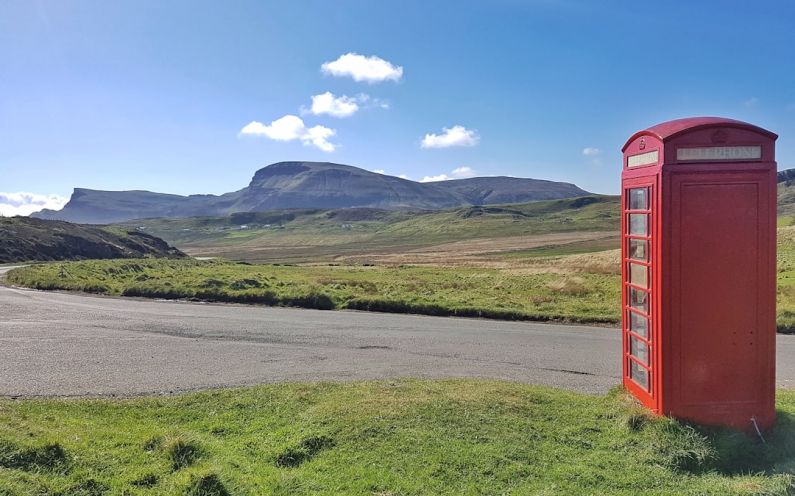 Remote Challenges - a red phone booth sitting on the side of a road